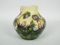 Moorcroft - A small Moorcroft Pottery vase decorated in the Hepatica pattern,