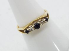 An 18 carat gold ring set with 3 sapphires and two diamonds, size O/P, approx 3.