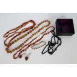 A collection of amber jewellery to include three necklaces, longest approximately 92 cm,