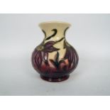 Moorcroft - A small Moorcroft Pottery vase decorated in the Pasque Flower pattern,