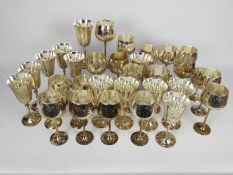 A collection of silver plated goblets.