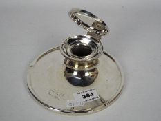 A large George V silver capstan inkwell with clear glass liner, Birmingham assay 1923,