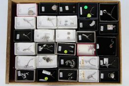 Costume Jewellery - a display case of sterling silver jewellery to include brooches, necklaces,