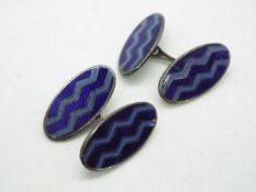 A gentleman's pair of silver cufflinks of oval form with blue enamel decoration