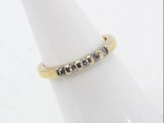 A yellow gold ring marked 9K (9 carat gold) set with five 5-point stones, size K+½, approx 1.