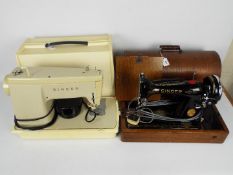 Two vintage Singer sewing machines contained in carry cases.