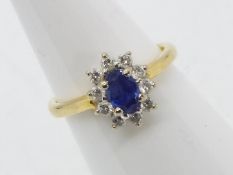 An 18ct yellow gold sapphire and diamond cluster ring, size M, approximately 4 grams all in.