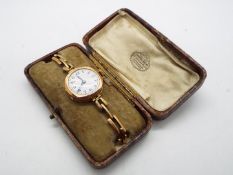 A lady's hallmarked 9 carat gold cased wristwatch with 9 carat gold expanding bracelet stamped 9 ct,