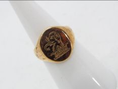 A 9 carat gold signet ring with elephant and crown crest, Birmingham hallmark, size J, approx 5.