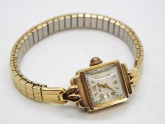 A lady's 9 carat gold cased Avia wristwatch with yellow metal expanding bracelet