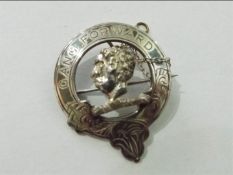 A hallmarked silver pin brooch with moor's head couped within a border scribed 'Gang Forward',