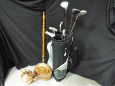 Golfing - a modern golf bag containing eight golf club to include Mercury, Bomber,