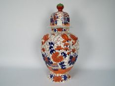 A very large Masons Ironstone octagonal section vase and cover with floral decoration,