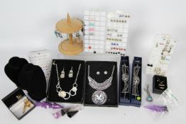 Costume jewellery - a quantity of boxed costume jewellery sets, paired earrings on display stands,