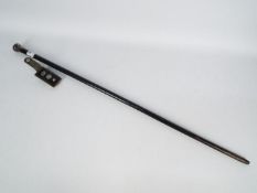 A silver topped walking stick and a set of two sterling silver golf ball markers contained in