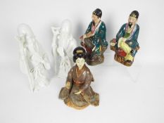 Five Oriental figurines, largest approximately 26 cm (h).