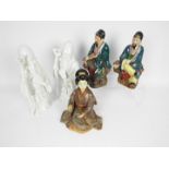 Five Oriental figurines, largest approximately 26 cm (h).