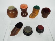 A collection of treen pin cushions to in