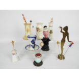 A collection of hat pin stands, predomin