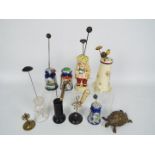 A collection of various hat pin stands t