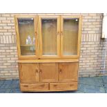 Ercol - A sideboard with upper display cabinet section,