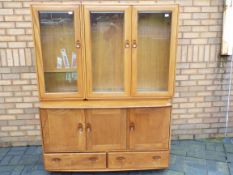 Ercol - A sideboard with upper display cabinet section,