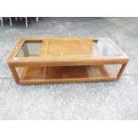 A coffee table with glass panel top, approximately 40 cm x 143 cm x 63 cm.