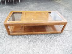A coffee table with glass panel top, approximately 40 cm x 143 cm x 63 cm.