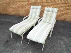 A pair of sun loungers. [2]