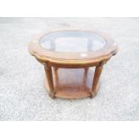 A glass topped lamp or occasional table