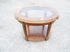 A glass topped lamp or occasional table