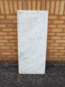 A white, veined marble counter top, appr