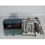 A mechanics metal tool box to include numerous ring and open-ended spanners and similar.