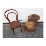 Two children's chairs, one a wicker tub style chair, the other a bentwood example.