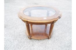 A glass topped lamp or occasional table