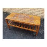 An Oriental coffee table with carved decoration, approximately 51 cm x 107 cm x 45 cm.