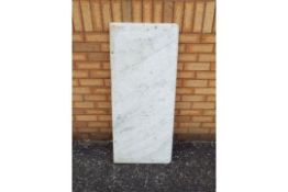 A white, veined marble counter top, approximately 117 cm x 51 cm x 2.2 cm.