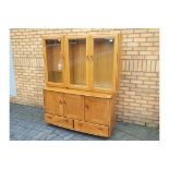 Ercol - A sideboard with upper display cabinet section,