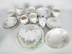 A quantity of Royal Doulton dinner and tea wares in the Carmel pattern.