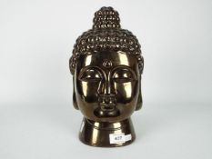 An Asian, bronzed ceramic Buddha head, approximately 30 cm (h).