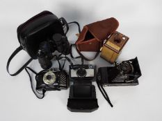 Photography - Vintage cameras and a pair of binoculars.