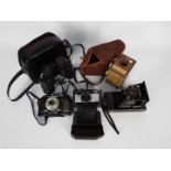 Photography - Vintage cameras and a pair of binoculars.