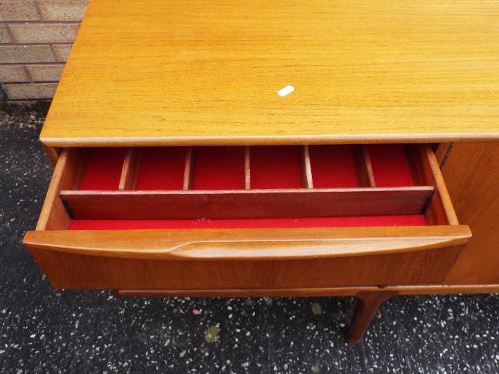 A H McIntosh - A mid century teak sideboard having central twin door cupboard flanked to one side - Image 3 of 5