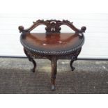 A demi lune console table with carved decoration on tripod supports,