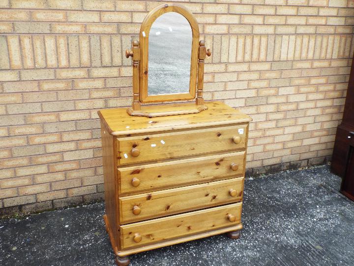 A pine chest of four drawers measuring approximately 85 cm x 86 cm x 46 cm and a pine framed swing