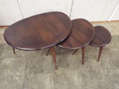 Ercol - A nest of three Pebble occasional tables, largest approximately 40 cm x 66 cm x 46 cm.