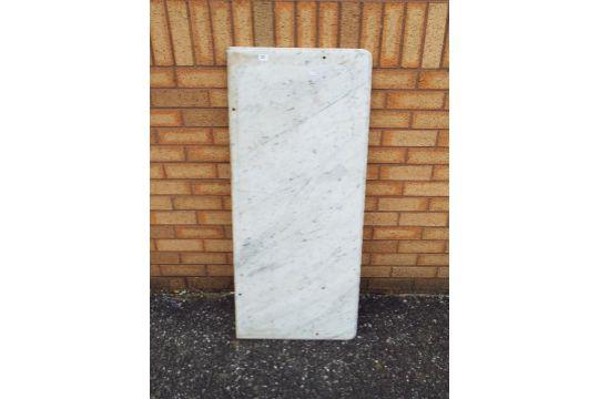 A white, veined marble counter top, appr