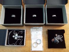 Jewellery - unused surplus retail stock - three white metal rings by 'Exclusively His', cased,
