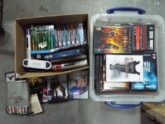 Two boxes of DVD's, feature films, television series and similar.