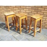 Three 20th century laboratory style wooden stools.